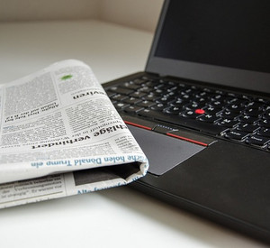 Zeitung im Hintergrund ein Laptop